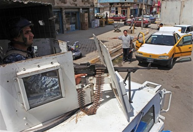 An Iraqi police officer secures the area from the top of an armored vehicle at a checkpoint in central Baghdad, Iraq, Saturday, Aug. 28, 2010. The Iraqi prime minister put his nation on its highest alert for terror attacks, as insurgents hammer Iraqi security forces preparing to take over for a U.S. combat mission that formally ends on Tuesday. (AP Photo/Khalid Mohammed)